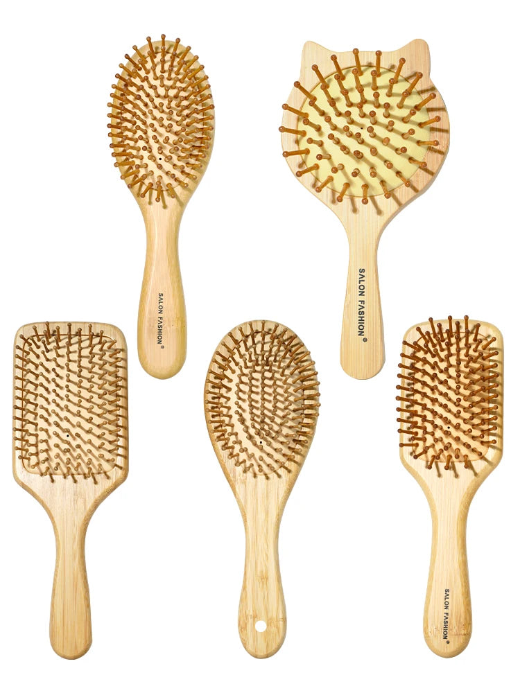 A collection of five wooden bamboo hair brushes with natural bristles shown against a white background.