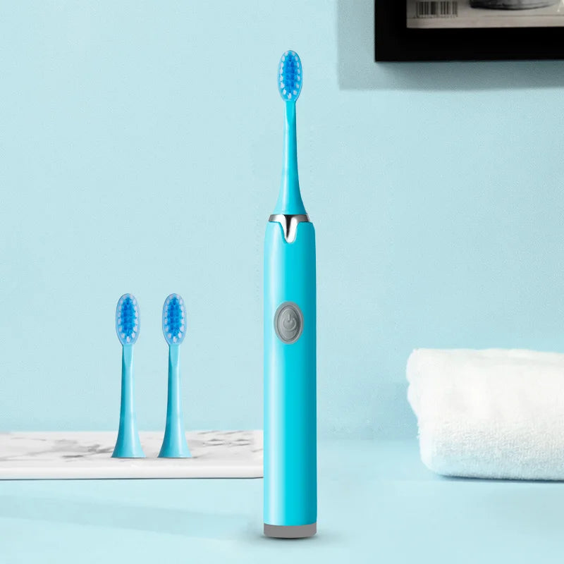 A blue sonic electric toothbrush with a replaceable head standing upright on a light blue surface.