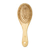 A light wood bamboo hair brush with numerous bristles for detangling and scalp massage.