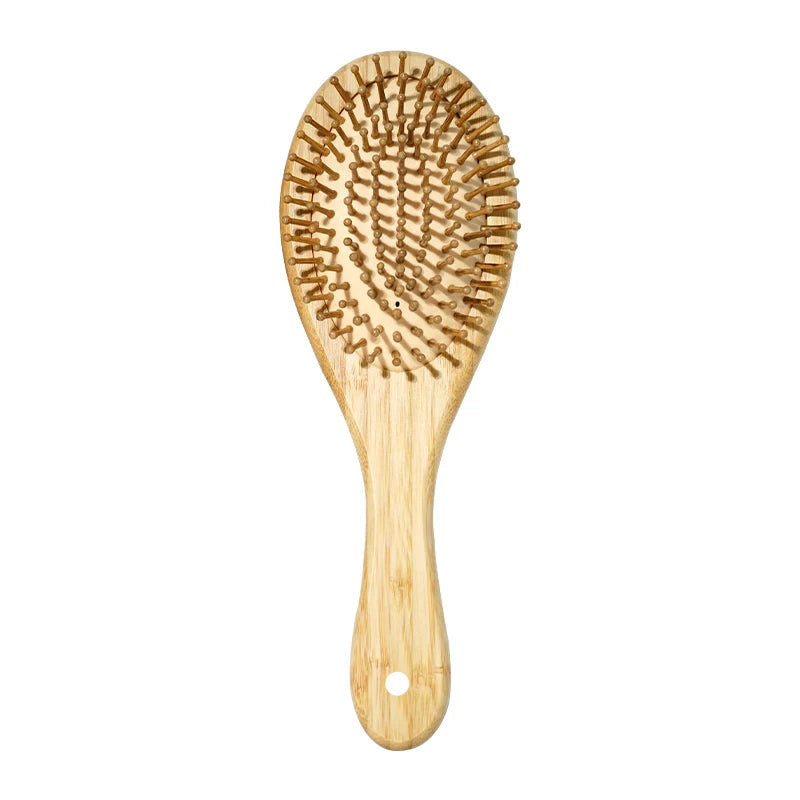 A light wood bamboo hair brush with numerous bristles for detangling and scalp massage.
