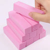A hand is holding a stack of pink nail buffer blocks for smoothing and polishing.