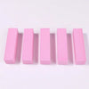 A row of five pink nail buffer blocks arranged horizontally.