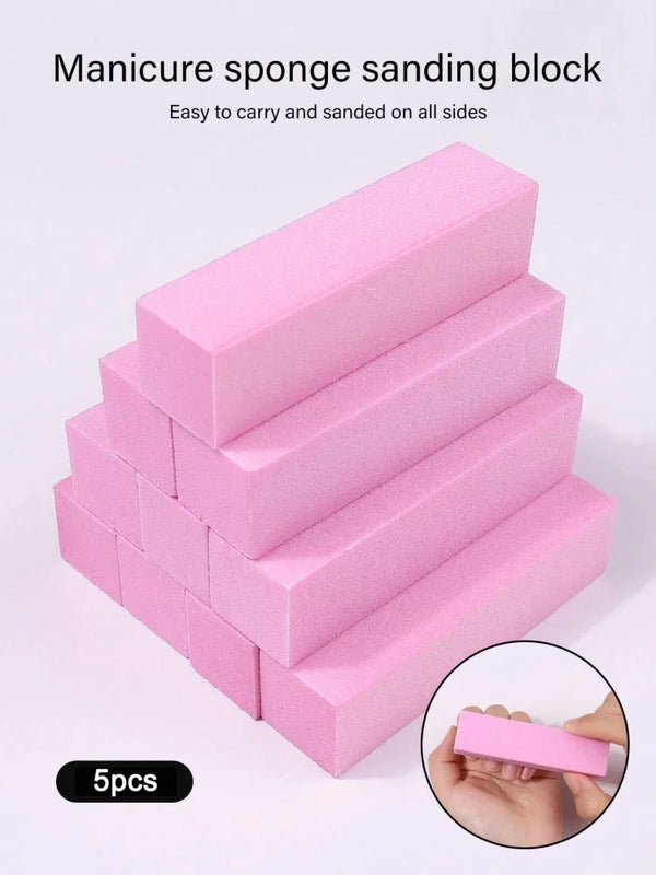 A stack of pink manicure sponge sanding blocks, showing various sizes and a hand holding one block.