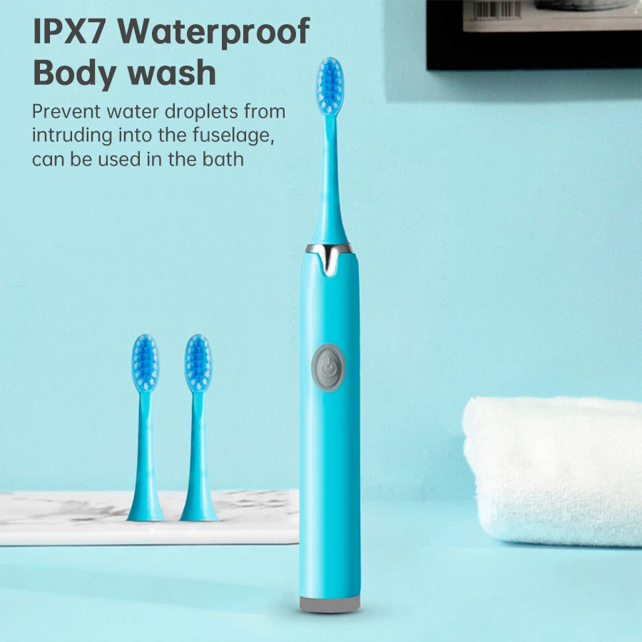 A blue sonic electric toothbrush with replaceable heads is shown next to a white towel on a light blue surface.