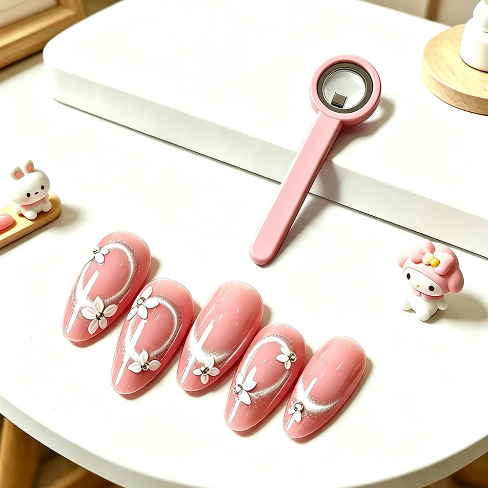 A pink magnetic nail art stick with a halo effect design is displayed on a white surface next to a small figurine.