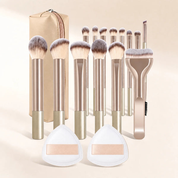 A collection of 17 makeup brushes and powder puffs in gold and beige tones displayed against a light background.