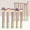 A set of seventeen makeup brushes and a powder puff with gold and rose gold handles and natural hair bristles.