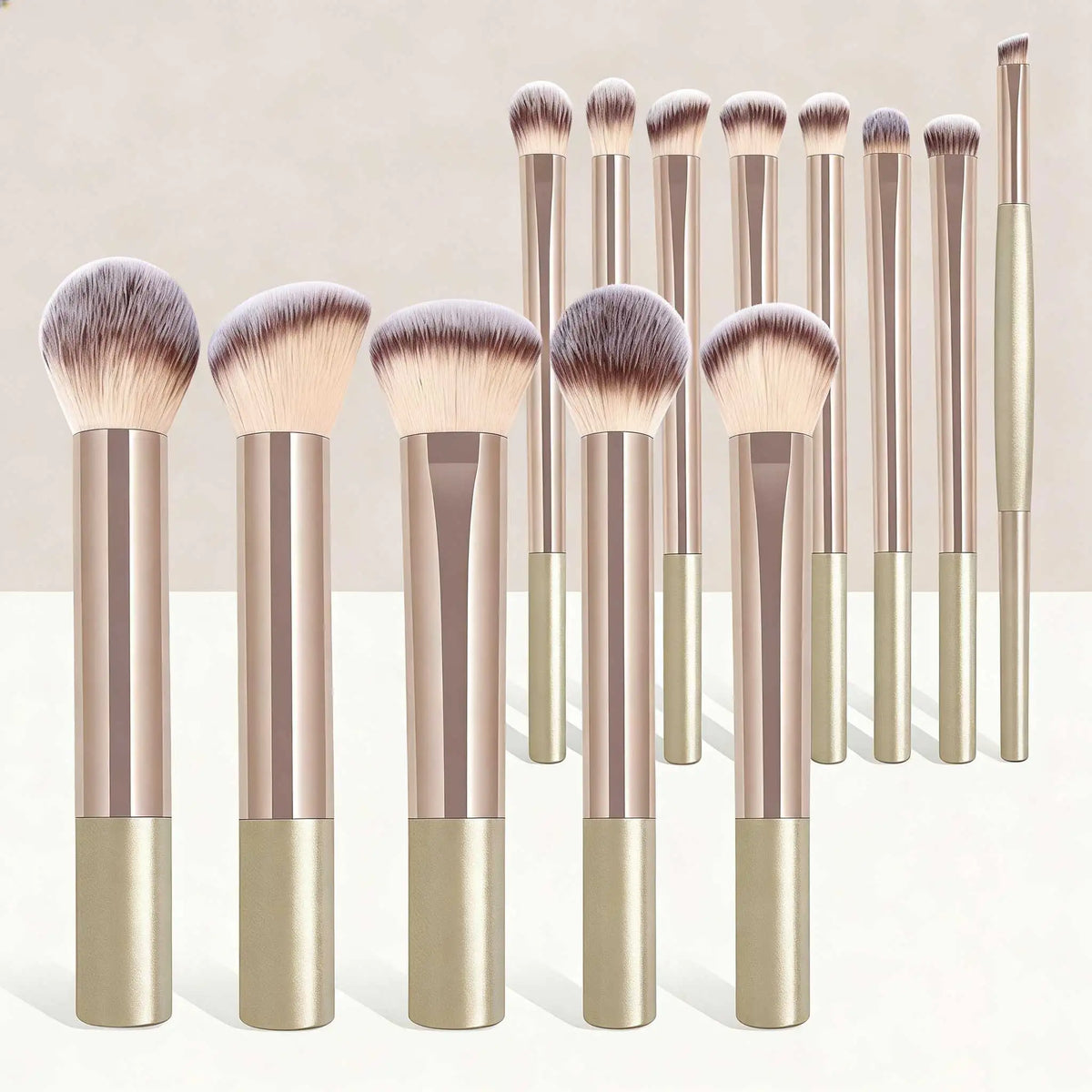 A set of seventeen makeup brushes and a powder puff with gold and rose gold handles and natural hair bristles.