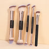 A set of five Maange professional synthetic makeup brushes with gold ferrules and black handles displayed against a light bac