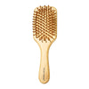 A light wood bamboo hair brush with numerous small bristles for detangling and scalp massage.