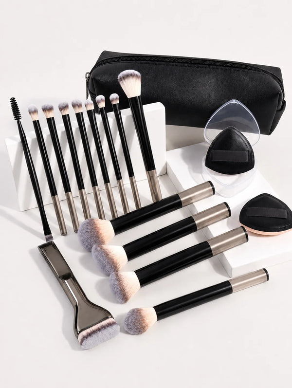 A set of makeup brushes with soft bristles and a black storage case are displayed on a white surface.
