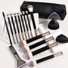 A set of makeup brushes with soft bristles and a black storage case are displayed on a white surface.