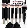 A set of complete makeup brushes with soft bristles shown in various shades and sizes.