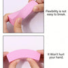 Hands demonstrate the flexibility and gentle use of a pink nail buffer block for smoothing and polishing.