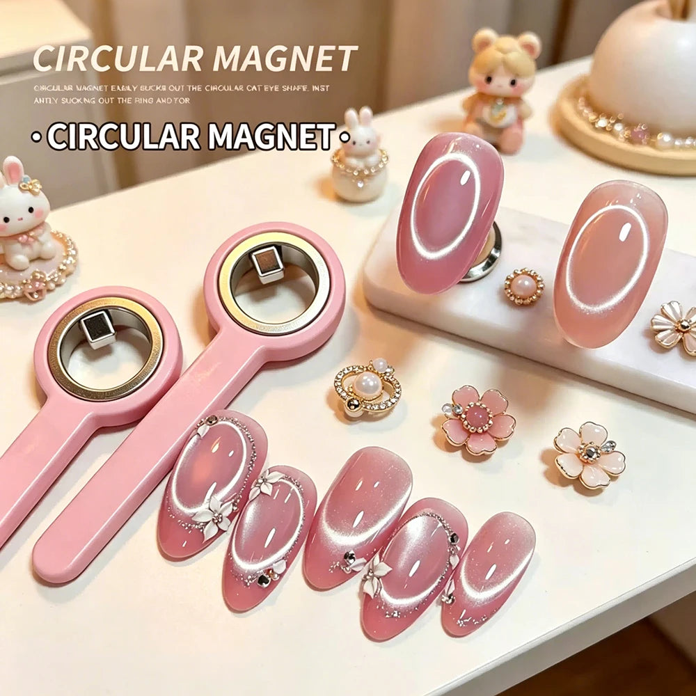 A collection of pink circular magnetic nail art sticks and decorative cat figurines displayed on a white surface.