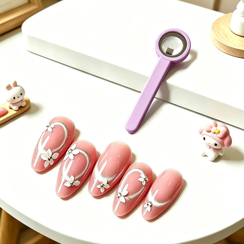 A set of pink magnetic nail art sticks featuring white floral designs and a purple magnifying tool.