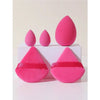 A set of five pink makeup sponges arranged on a white box.