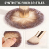 A close-up view of synthetic fiber bristles used for makeup application, showing a soft brown brush and powder puff.