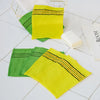 A set of five bright yellow and green exfoliating body mitts are displayed on a white surface.