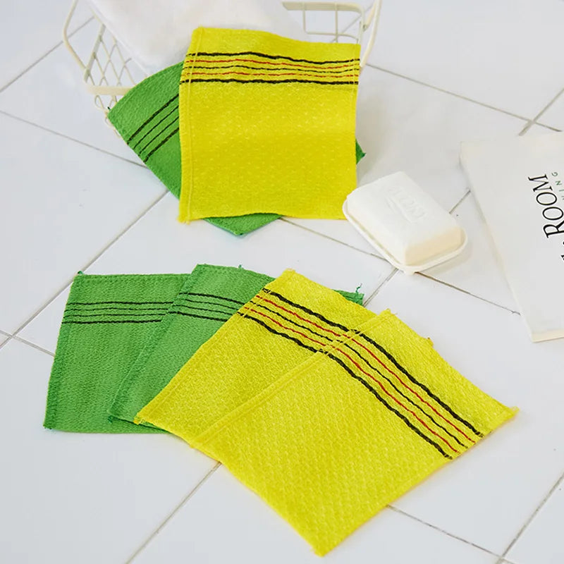 A set of five bright yellow and green exfoliating body mitts are displayed on a white surface.