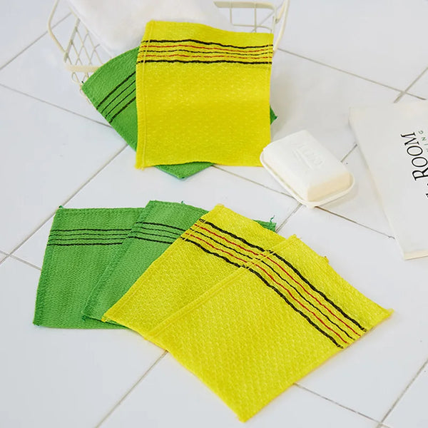 A set of five bright yellow and green exfoliating body mitts are displayed on a white surface.