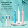 Three smart electric toothbrushes in blue, white, and pink are displayed on a stand.