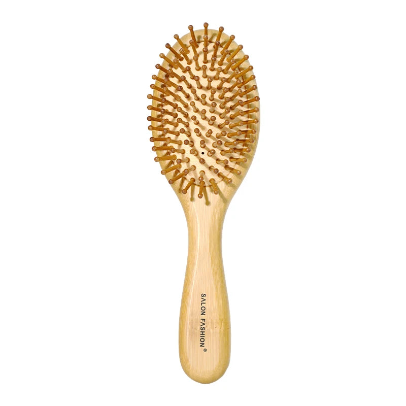 A light wood bamboo hair brush with numerous fine bristles for detangling and scalp massage.