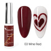 Botella de esmalte Venalisa Liner color rojo vino y tres uñas postizas con diseño de corazón.