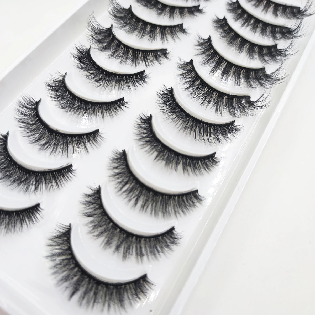 A tray of natural 3D mink false eyelashes displayed in a row.