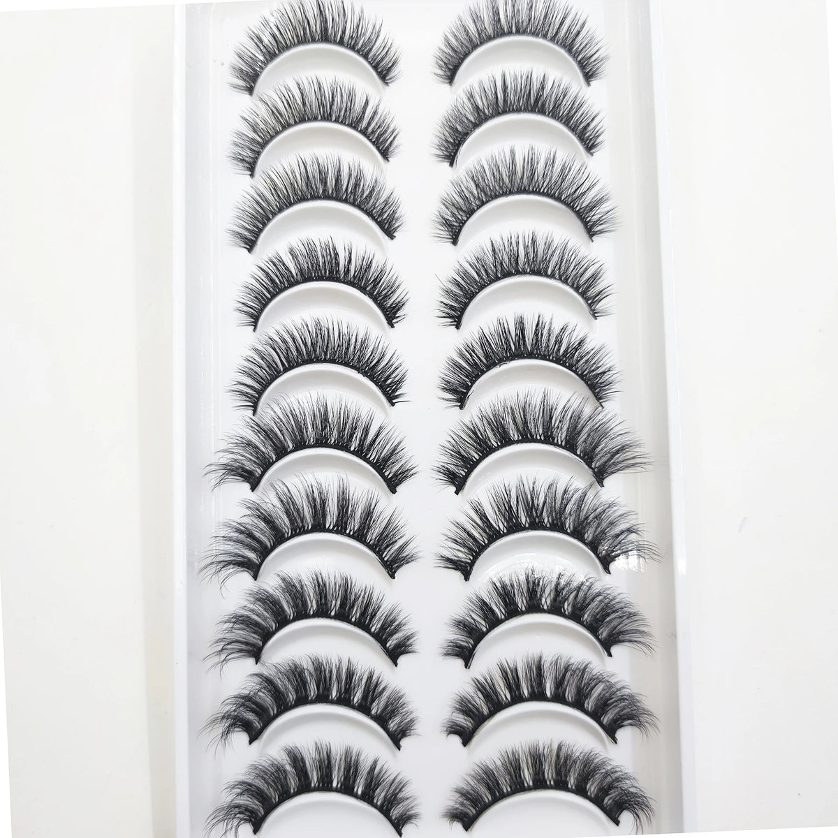 A display of natural 3D mink false eyelashes in various styles and lengths.