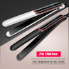 A pair of black and white 2 in 1 flat irons used for hair straightening and curling.