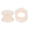 A pair of translucent pink silicone ear tunnels and plugs.