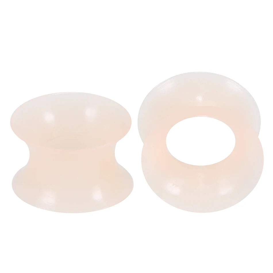 A pair of translucent pink silicone ear tunnels and plugs.