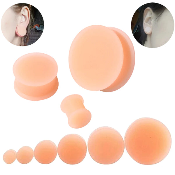 A collection of flexible silicone double flared ear tunnels in various shades of peach and nude.