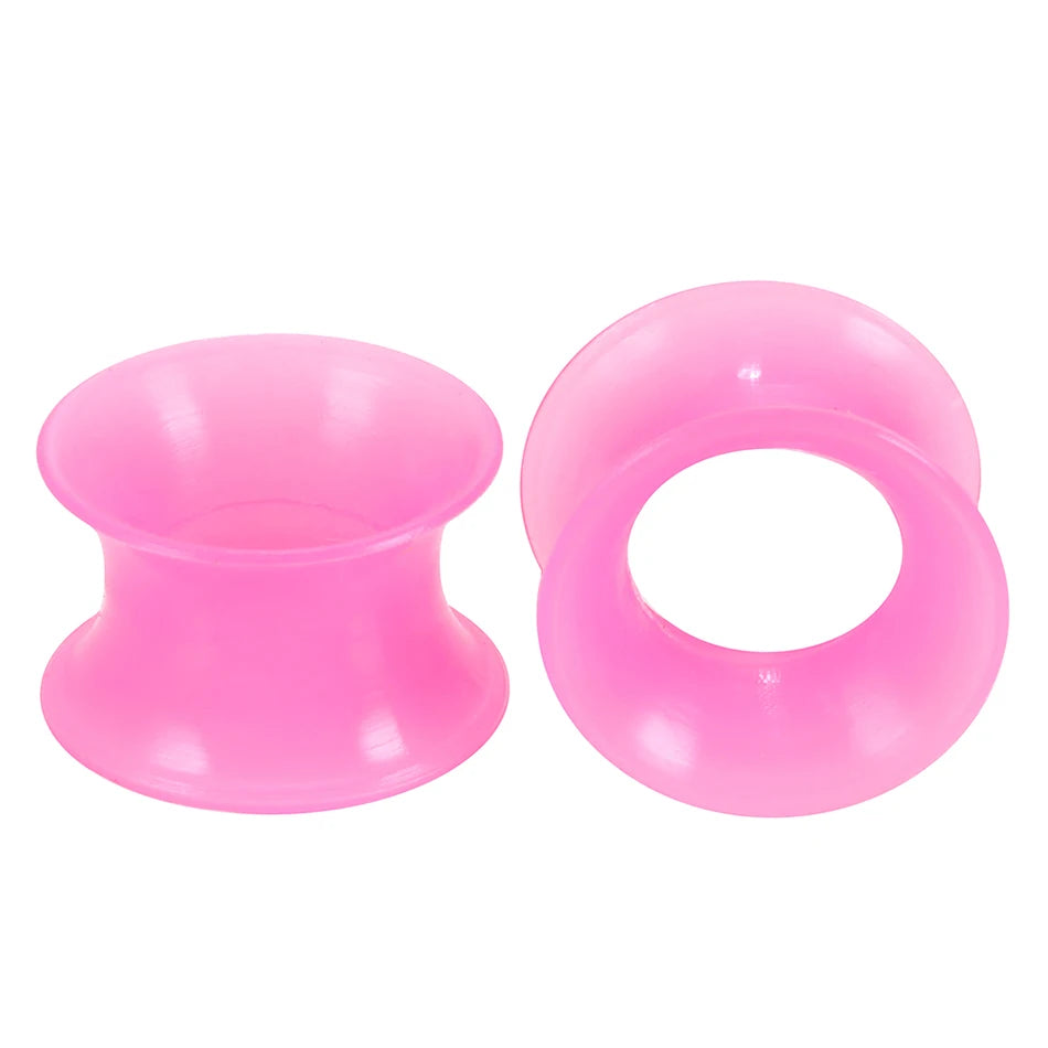 A pair of pink flexible silicone ear tunnels and plugs.