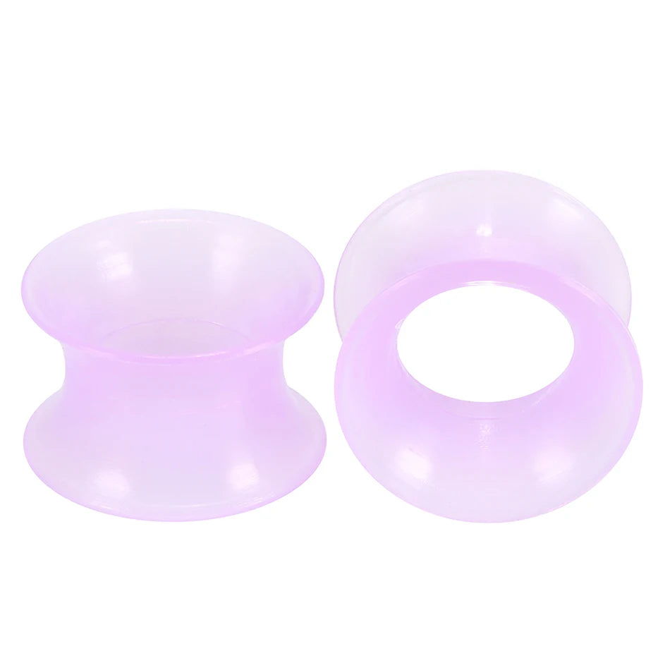 A pair of translucent purple silicone ear tunnels and plugs.