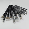 A set of professional makeup brushes used for contouring and highlighting, shown lying on a white surface.