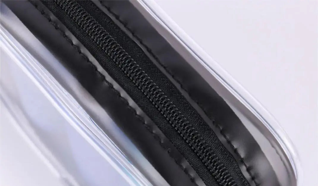 Close-up of a clear waterproof travel cosmetic bag with a black zipper detail.