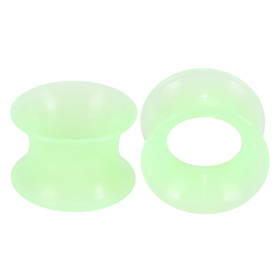 A pair of translucent light green flexible silicone ear tunnels and plugs.