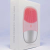 A white box for a sonic facial cleansing brush with a pink and silver device visible inside.