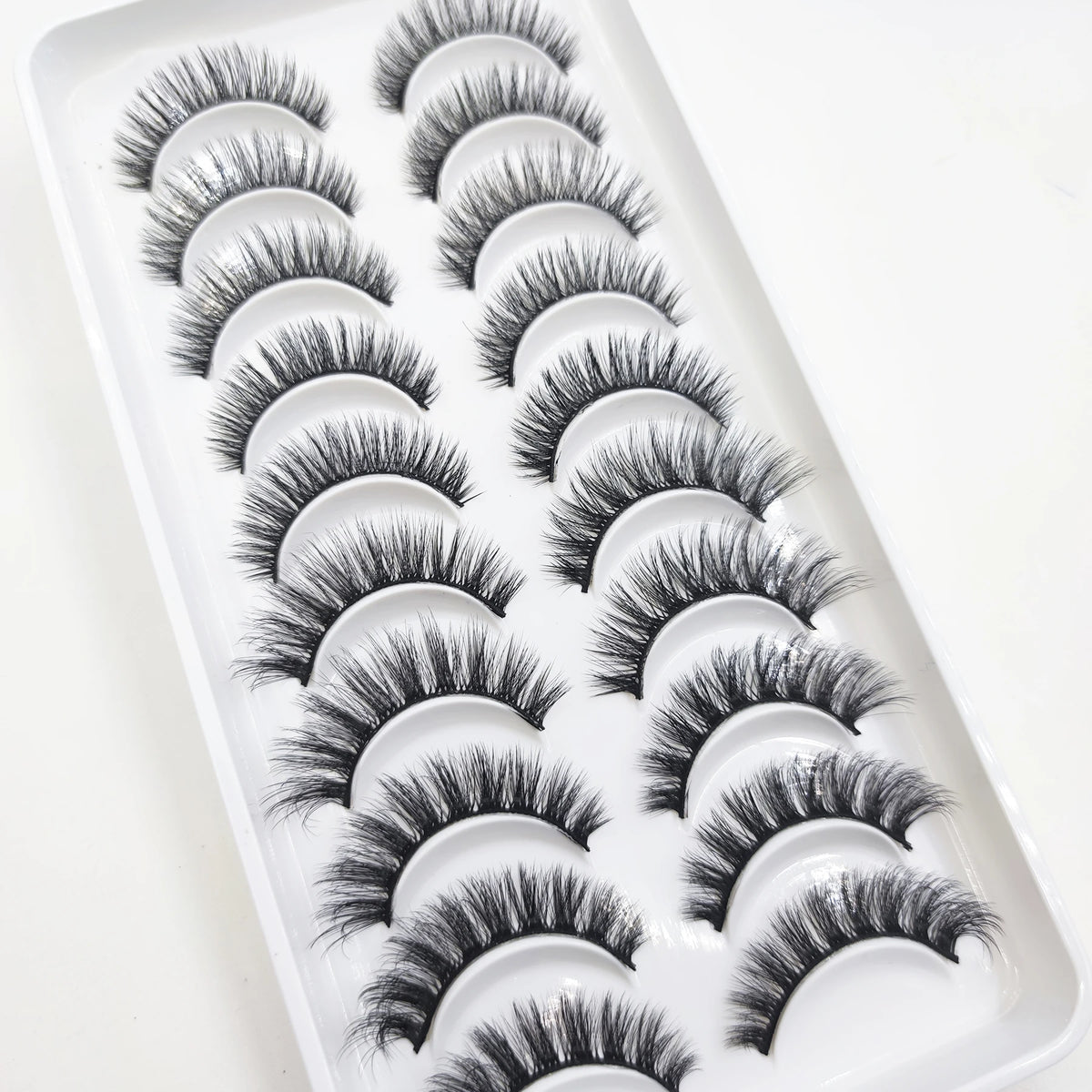 A tray of natural 3D mink false eyelashes displayed for sale.