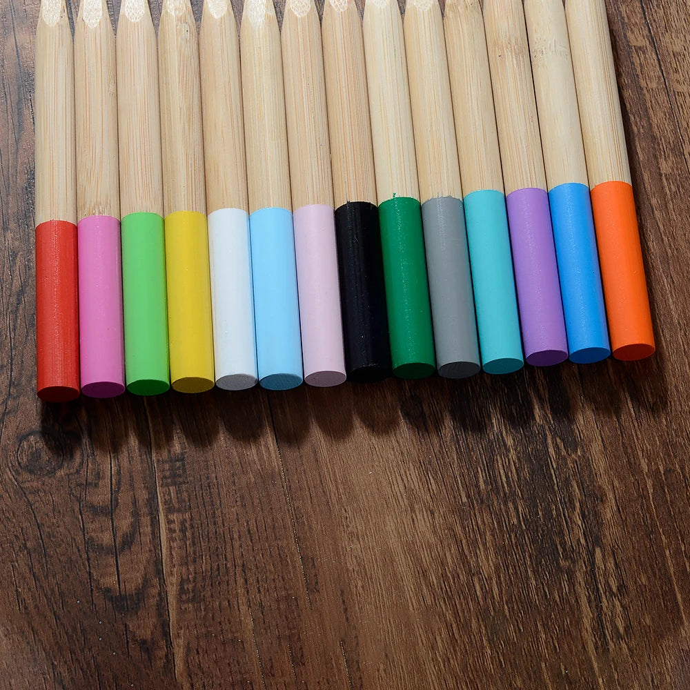A row of ten eco-friendly bamboo toothbrushes in various bright and muted colors arranged horizontally.