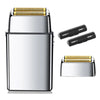 A silver electric shaver with gold accents and replacement shaver heads shown next to the main unit.