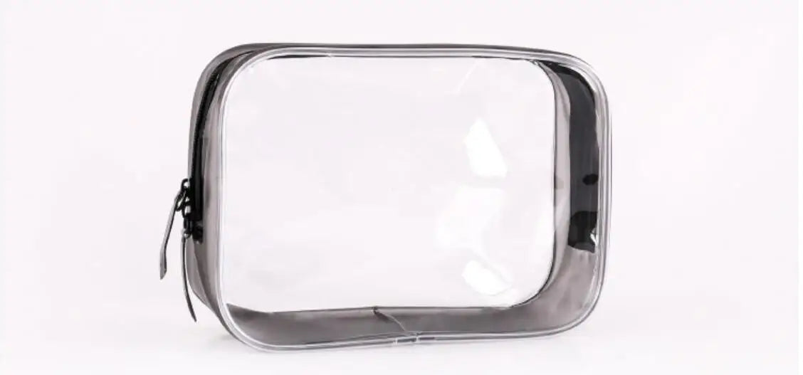 A clear waterproof travel cosmetic bag with a black trim, shown from the top view.