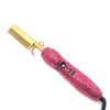 Fer à lisser en céramique rose avec strass et une attache en peigne dorée.