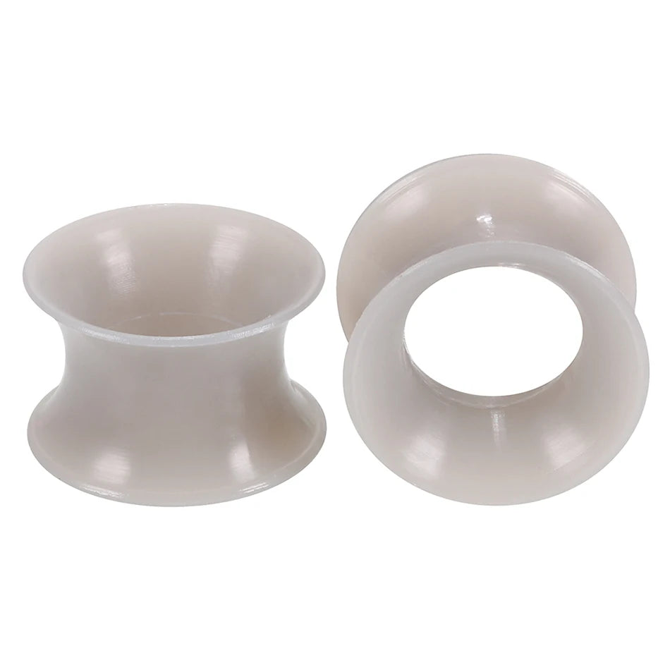 A pair of translucent silicone ear tunnels and plugs for hearing aid or custom ear devices.