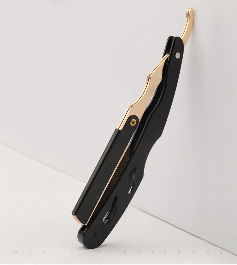 A black and gold professional straight edge barber razor shown in profile against a white background.