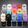 A collection of colorful flexible silicone ear tunnels and plugs in various shades including pink, red, green, yellow, and cl