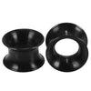 A pair of black flexible silicone ear tunnels and plugs.