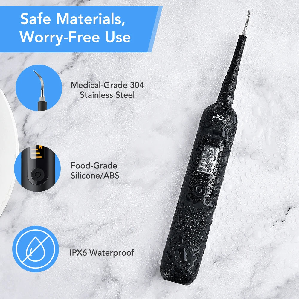 A black electric dental scaling and whitening tool is shown against a white marble background with safety features highlighte